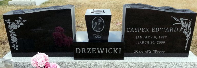 Granite monument on a double plot with two headstones and a above ground urn in between. Casper Edward.