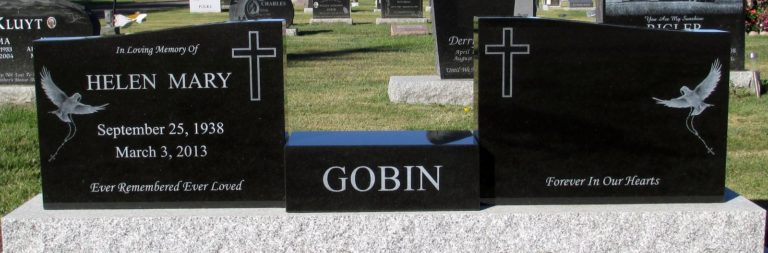 Two black monuments with a shorter rectangle piece in the middle that reads the last name GOBIN. The left monument that is connected that the rectangle one reads in loving memory of Helen Mary. September 25, 1938-March 3, 2013. Ever remembered, ever loved. There is a dove flying with a cross necklace in it's mouth. There is a plain cross on the right hand side. The right hand monument that is attached to the rectangle monument has no name on it but as the same dove soaring with a cross necklace in it's mouth.