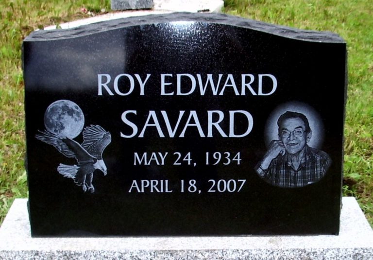 Black Granite Monument with an eagle soaring past the moon and a self portrait on the right hand side.