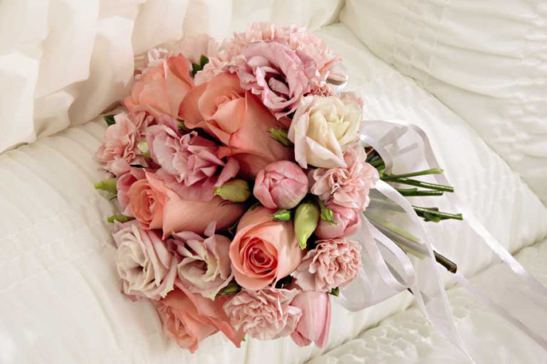 Funeral Flowers in Casket, pink roses and flowers in a bouquet