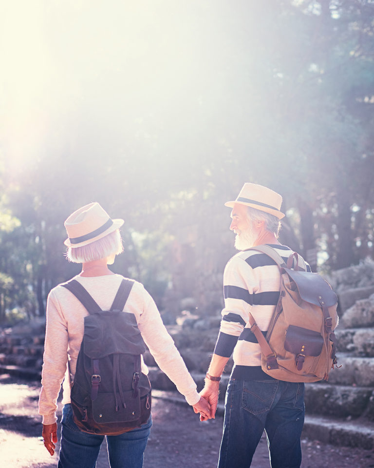 Travel and tourism. Senior family couple walking together on ancient sightseeing.