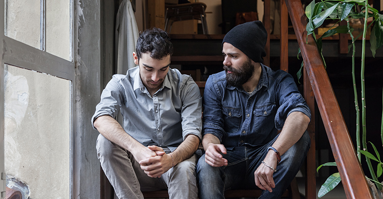 Two men talking to each other about emotions