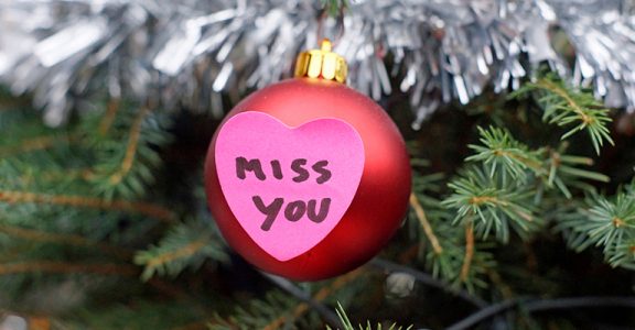 Miss you written on a heart memo with Christmas