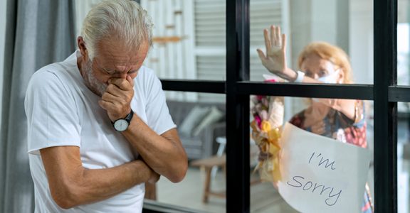 Selective focus on elderly covid-19 patients be isolated. Senior woman visiting husband in quarantine through window. Concepts of Home Isolation for Protecting vulnerable from Coronavirus infection.