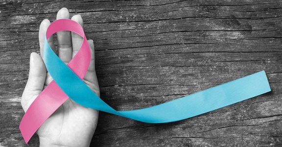 Pink blue ribbon awareness (isolated with clipping path) bow color for newborn birth defect, Sudden Infant Death Syndrome (SIDS), pregnancy Loss on helping hand