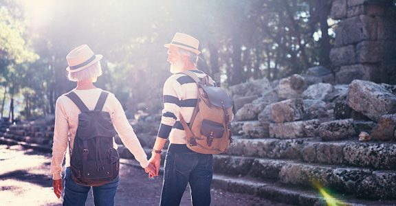 Travel and tourism. Senior family couple walking together on ancient sightseeing.